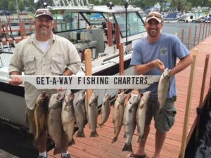 2 men holding fish from Getaway Fishing Charters